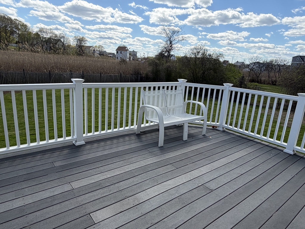 175 Spring Street, Unit 1 Hull, MA 02045 - Photo 7 of 15 a view of a deck with two chairs and wooden floor