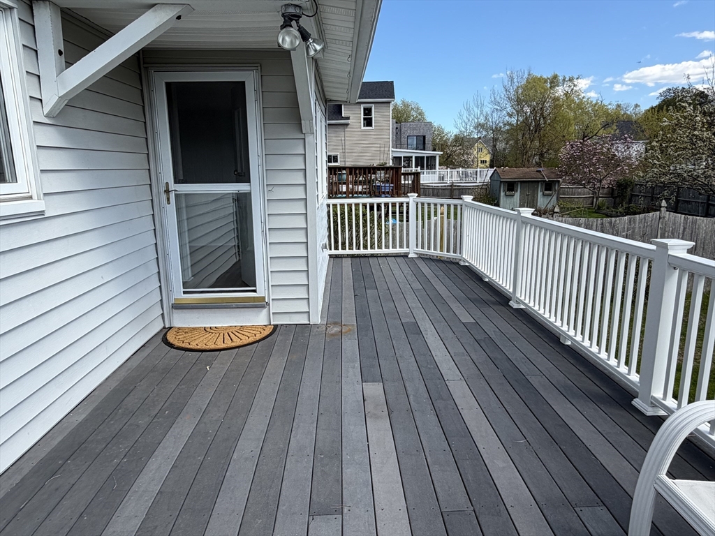175 Spring Street, Unit 1 Hull, MA 02045 - Photo 9 of 15 a view of a wooden deck with a yard