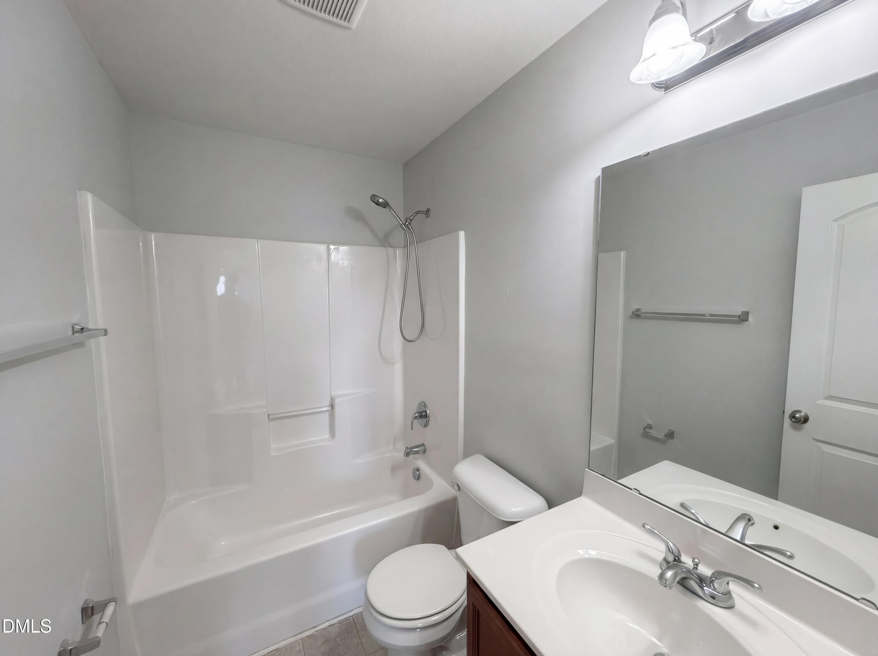 4716 Queen Pierrette Street Raleigh, NC 27610 - Photo 14 of 15 a bathroom with a toilet a sink and bathtub