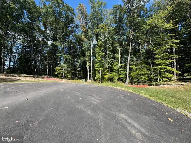 a street sign on a wall next to a road