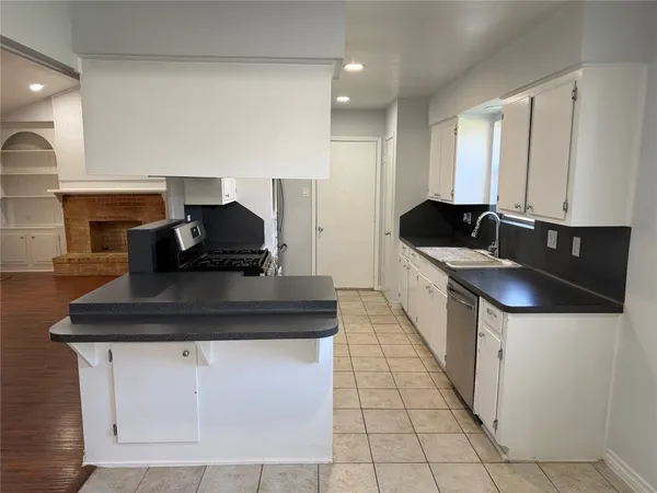 a kitchen with a sink and cabinets