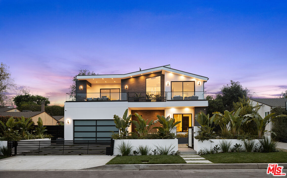 3025 Midvale Avenue Los Angeles, CA 90034 - Photo 1 of 1 a front view of a house with a yard