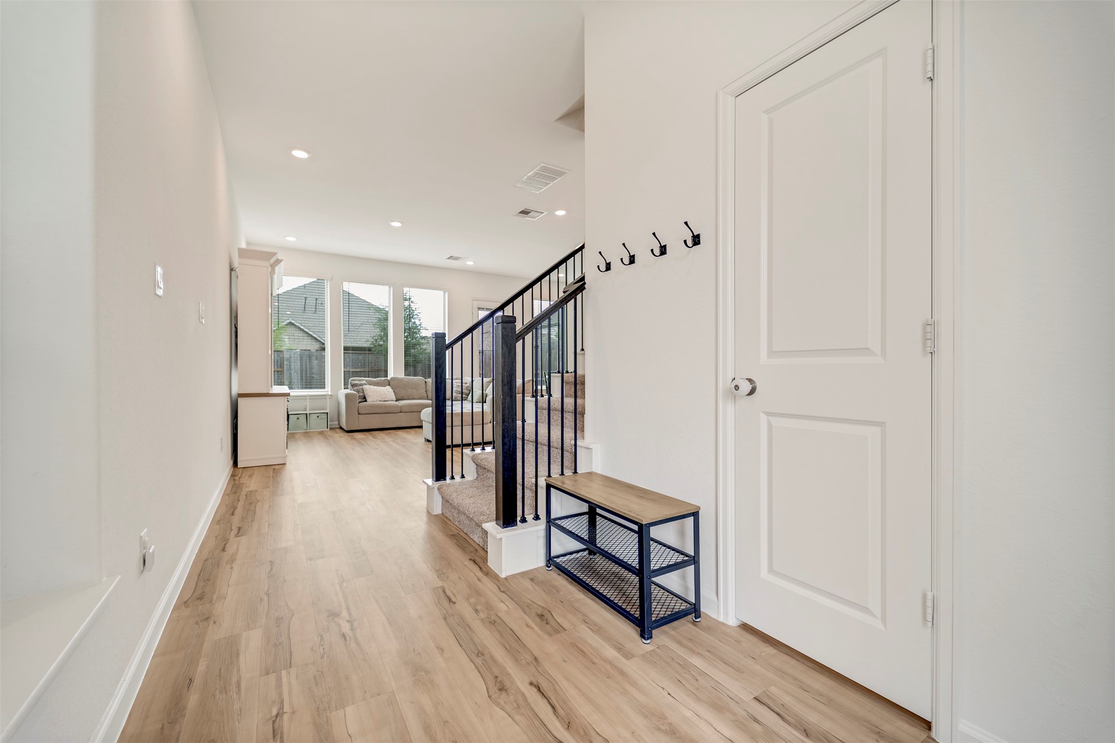4127 Champlain Way Iowa Colony, TX 77583 - Photo 5 of 35 a view of a hallway with wooden floor and staircase