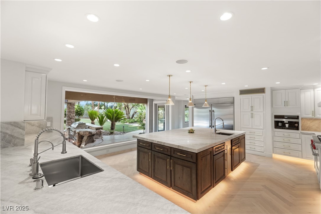 105 Quail Run Road Henderson, NV 89014 - Photo 11 of 88 Kitchen with white cabinets, light stone counters,