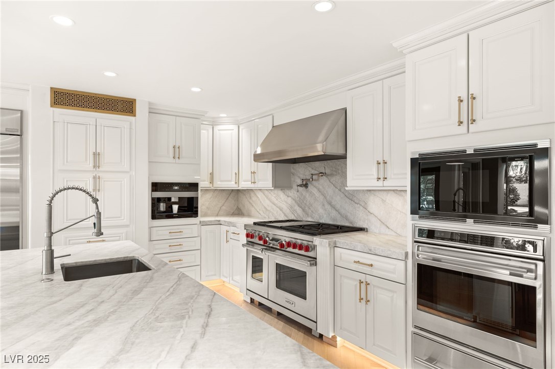 105 Quail Run Road Henderson, NV 89014 - Photo 15 of 88 Kitchen with black appliances, wall chimney exhaus