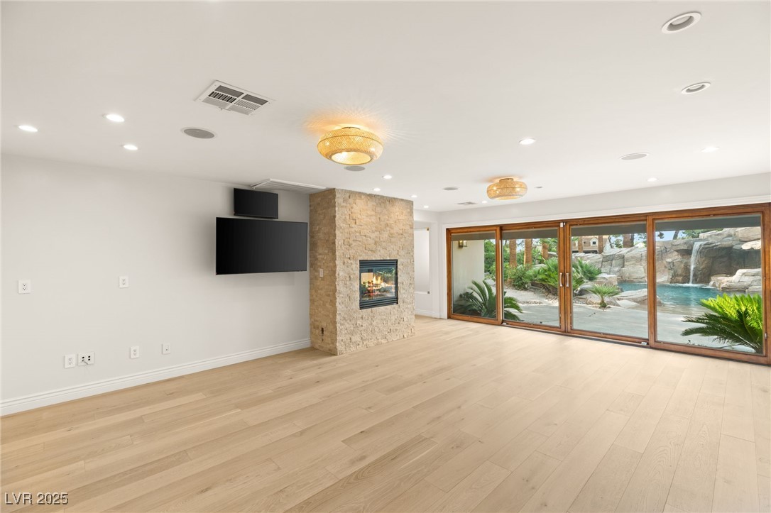 105 Quail Run Road Henderson, NV 89014 - Photo 20 of 88 Unfurnished living room featuring light wood finis