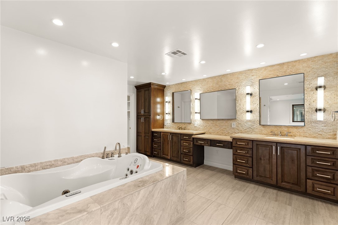 105 Quail Run Road Henderson, NV 89014 - Photo 24 of 88 Bathroom featuring vanity, a tub with jets, decora