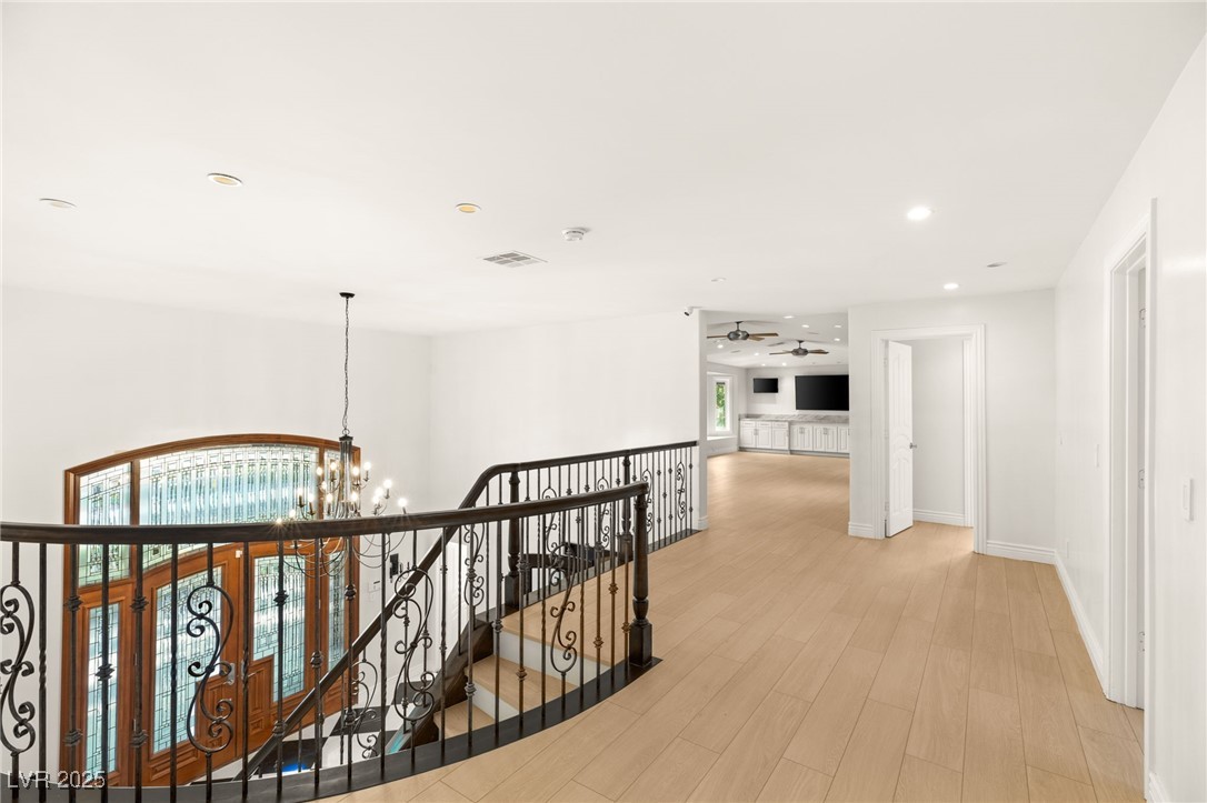 105 Quail Run Road Henderson, NV 89014 - Photo 40 of 88 Corridor featuring a chandelier, an upstairs landi
