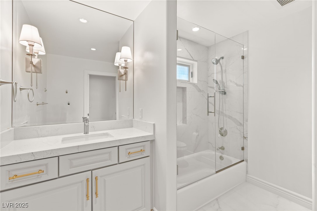 105 Quail Run Road Henderson, NV 89014 - Photo 45 of 88 Bathroom featuring marble look tiles, vanity, show