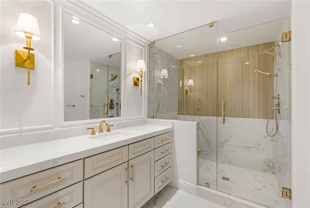 105 Quail Run Road Henderson, NV 89014 - Photo 48 of 88 Bathroom featuring marble look tiles, a marble fin