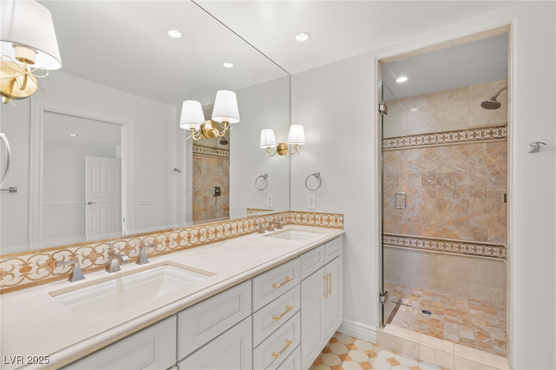105 Quail Run Road Henderson, NV 89014 - Photo 50 of 88 Full bathroom featuring a stall shower, double van