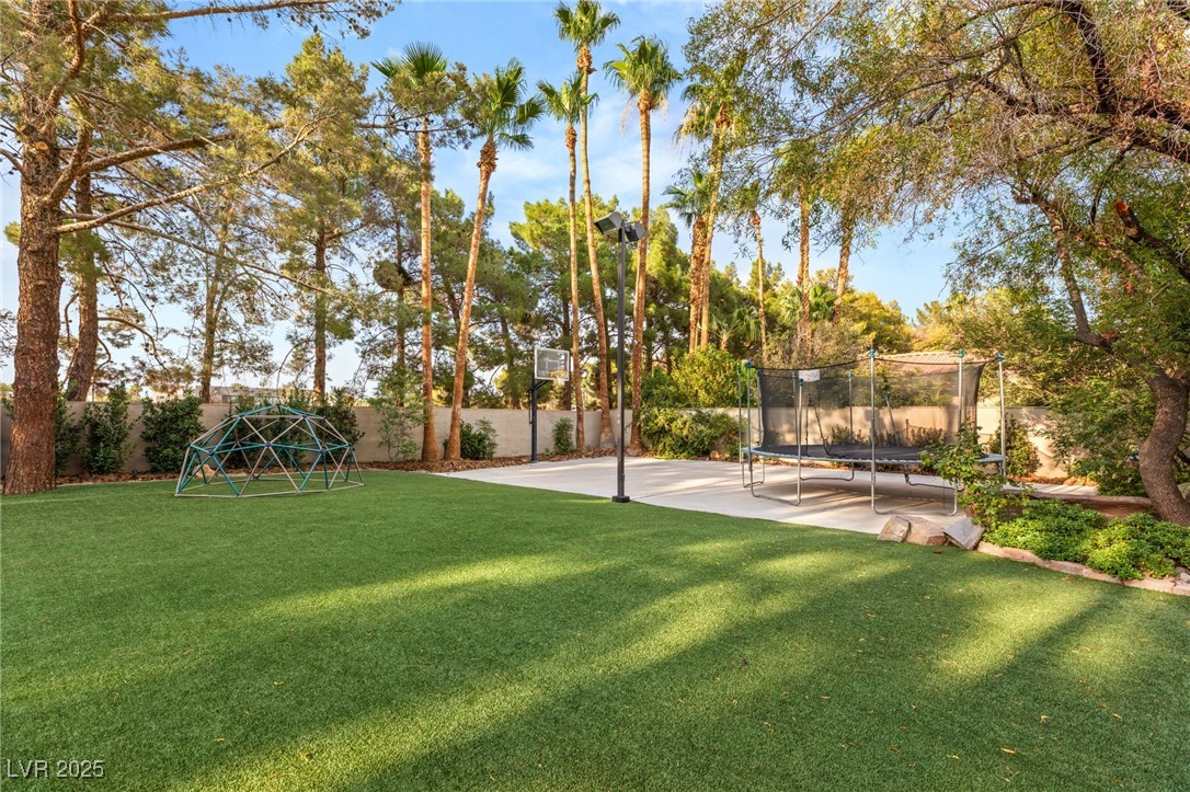 105 Quail Run Road Henderson, NV 89014 - Photo 64 of 88 Fenced backyard with a trampoline and a playground