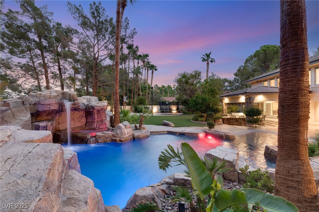 105 Quail Run Road Henderson, NV 89014 - Photo 74 of 88 Pool at dusk featuring a patio, an outdoor pool, a