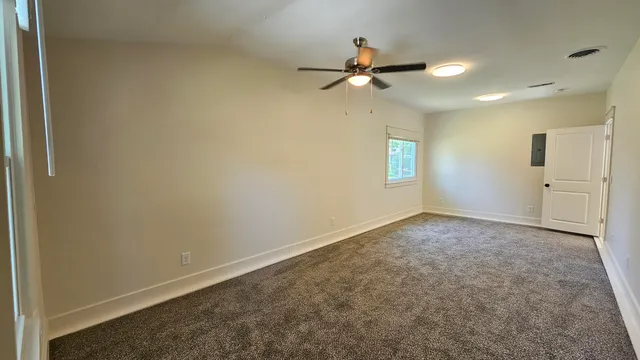 an empty room with stairs and windows