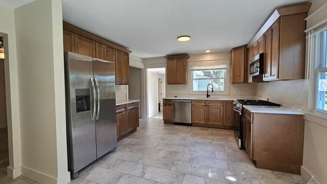 en empty room with windows and chandelier