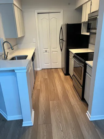 a kitchen with a sink a refrigerator a washer and dryer
