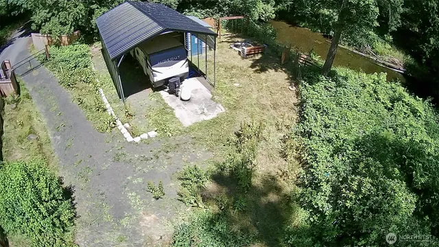 a view of a backyard with plants and a garden