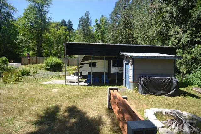 a view of house with backyard and furniture