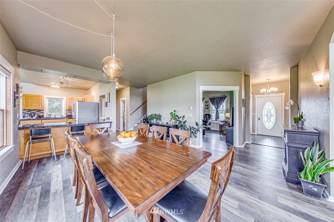 10 Klahn Country Road Sequim, WA 98382 - Photo 8 of 40 a dining room with wooden floor a chandelier a wooden table and chairs