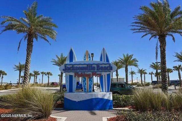 a view of a house with a swimming pool and sitting area