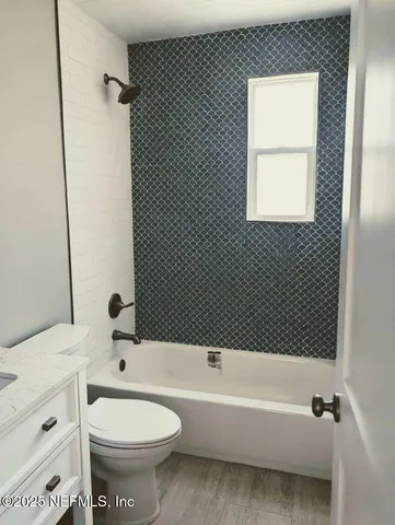 a bathroom with a toilet a sink and bathtub