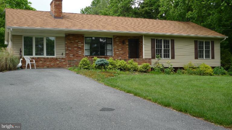 13852 Penn Shop Road Mount Airy, MD 21771 - Photo 4 of 30 a view of a house with brick walls and a yard with plants