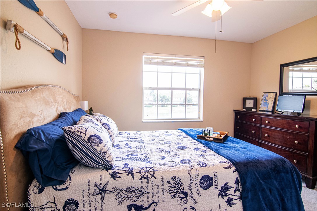 11753 Eros Road Lehigh Acres, FL 33971 - Photo 14 of 34 a bedroom with a bed and a window