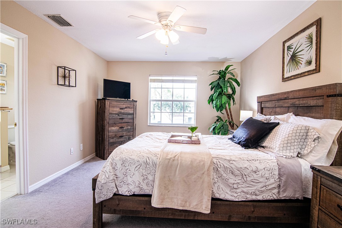11753 Eros Road Lehigh Acres, FL 33971 - Photo 19 of 34 a bedroom with a bed and a window