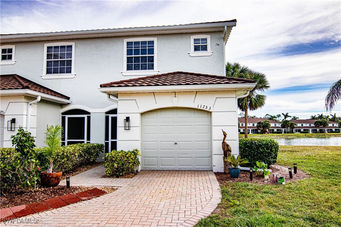 11753 Eros Road Lehigh Acres, FL 33971 - Photo 3 of 34 a front view of a house with a garden