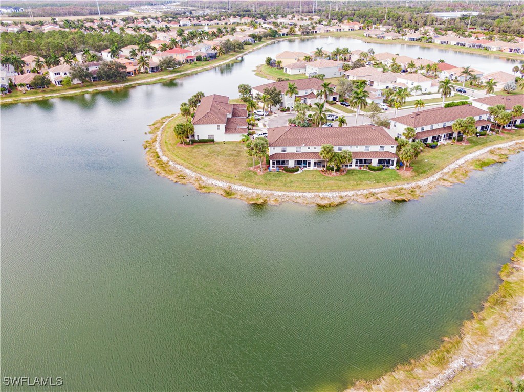 11753 Eros Road Lehigh Acres, FL 33971 - Photo 32 of 34 an aerial view of residential houses with outdoor space and lake view