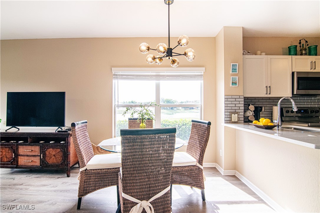 11753 Eros Road Lehigh Acres, FL 33971 - Photo 6 of 34 a living room with furniture a flat screen tv and a window