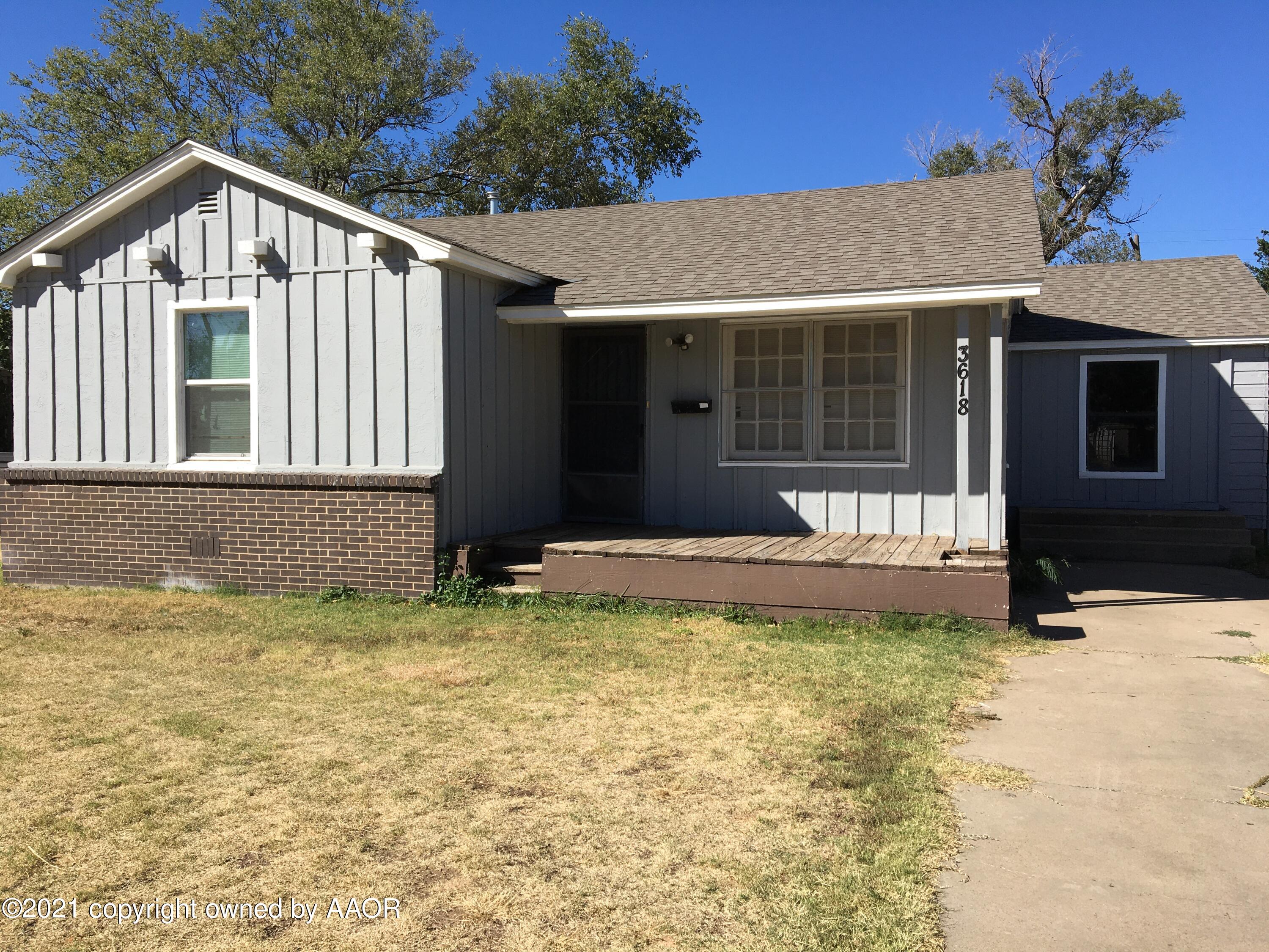 3618 South Travis Street Amarillo, TX 79110 - Photo 1 of 7 a front view of a house with a yard