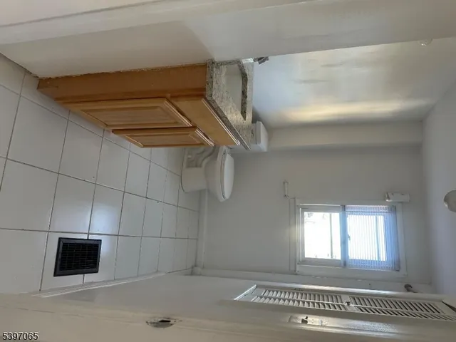 a view of a livingroom with a white wall and a dishwasher