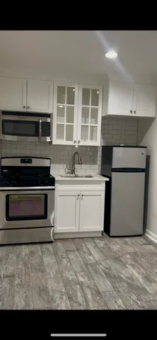 a view of a room with wooden floor and window