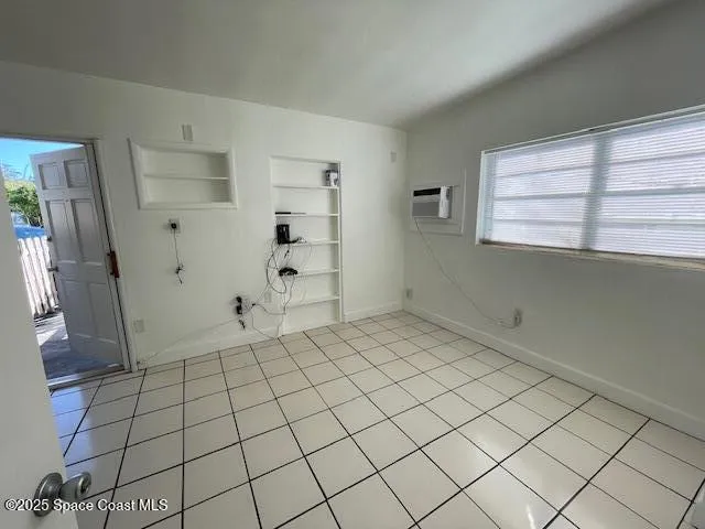 a view of an empty room and a window