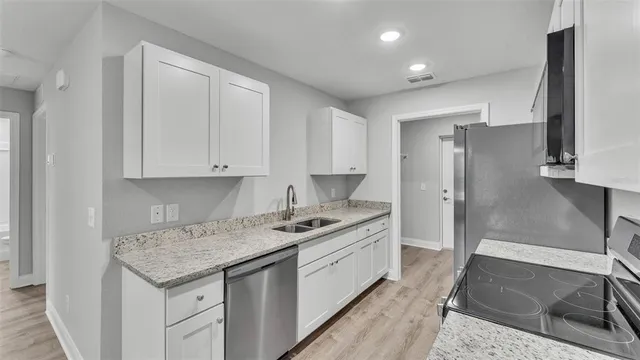 a kitchen with a sink stove and refrigerator