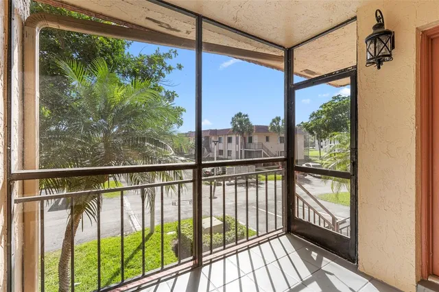 a view of a balcony with wooden floor