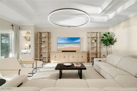 a living room with furniture a rug and a painting