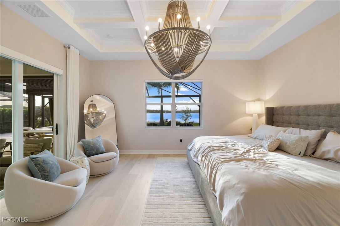 13670 Blue Bay Circle Fort Myers, FL 33913 - Photo 15 of 50 a bed room with a bed and a large mirror