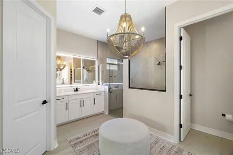 a spacious bathroom with a granite countertop sink a toilet and shower
