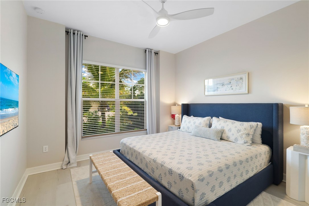 13670 Blue Bay Circle Fort Myers, FL 33913 - Photo 19 of 50 a bedroom with a large bed and a large window
