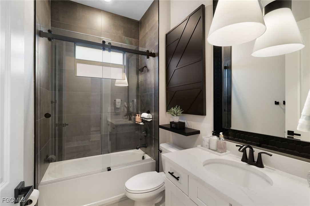 13670 Blue Bay Circle Fort Myers, FL 33913 - Photo 20 of 50 a bathroom with a sink a toilet and shower