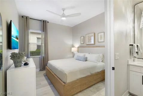 a bedroom with a bed and a flat tv screen