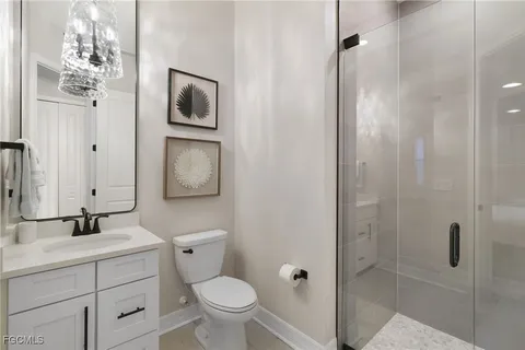 a bathroom with a toilet sink and shower