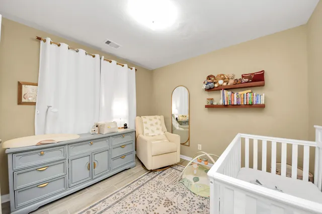 a spacious bathroom with a granite countertop sink and a mirror