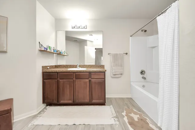 a bedroom with a bed and a flat tv screen on dresser