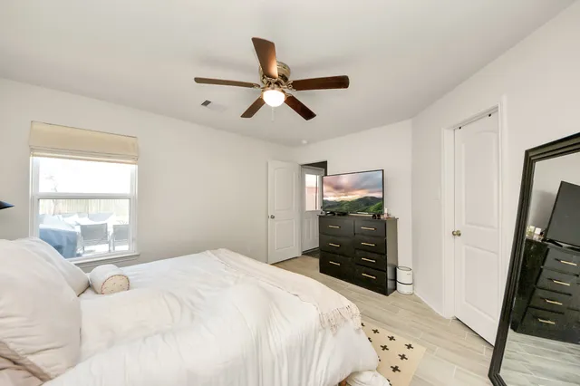 a bedroom with a bed and wooden floor