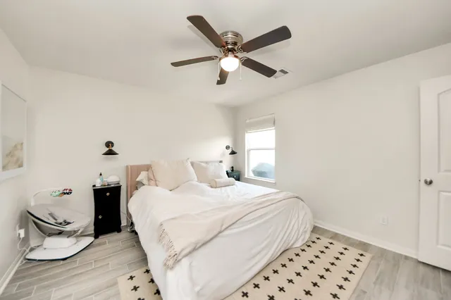 a bedroom with a bed and a window