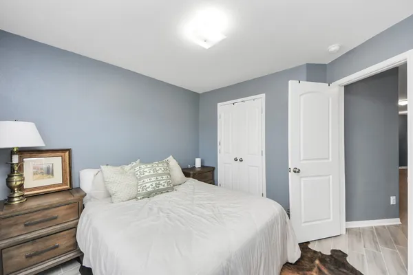 a bedroom with a bed and a window