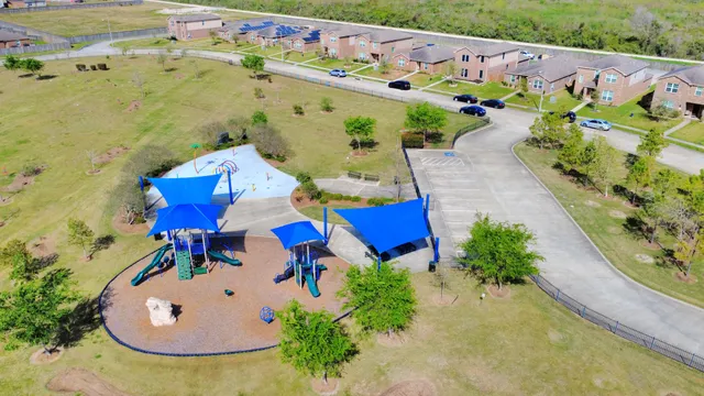 an aerial view of residential houses with outdoor space